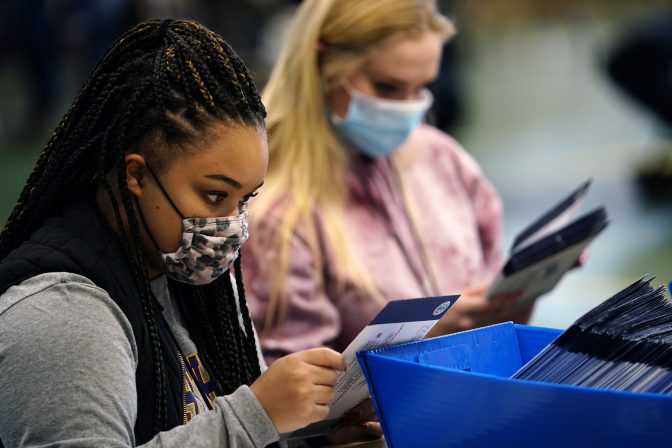 Chester County, Pa., election workers check mail-in and absentee ballots for the 2020 General Election in the United States at West Chester University, Tuesday, Nov. 3, 2020, in West Chester, Pa.