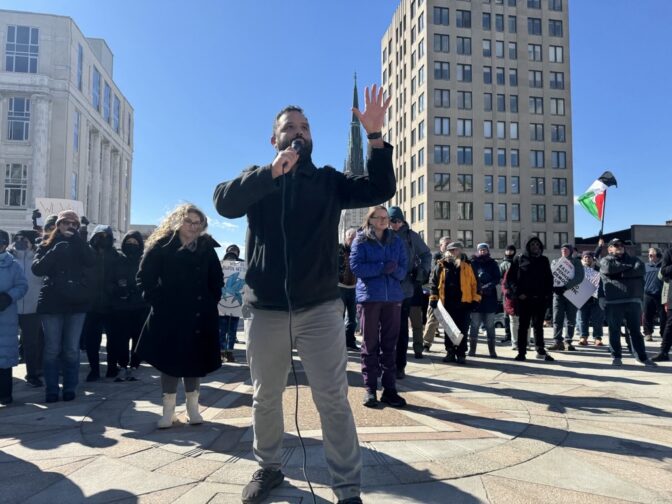 State Rep. Dave Madsen, D-Dauphin, encouraged protesters to pressure their state-level lawmakers, especially Republicans in the state Senate, to add civil rights protections to state law. Rep. Nikki Rivera, D-Lancaster, in blue, also spoke at the protest outside the Pennsylvania Capitol on Monday, Feb. 17, 2025.